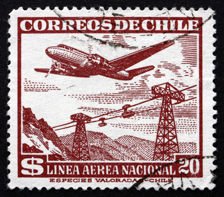 CHILE - CIRCA 1954: a stamp printed in the Chile shows Plane over Cable Cars, circa 1954のeditorial素材