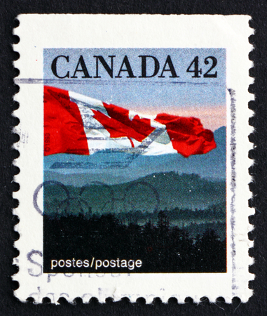 CANADA - CIRCA 1991: a stamp printed in the Canada shows Canadian Flag and Hills, circa 1991のeditorial素材
