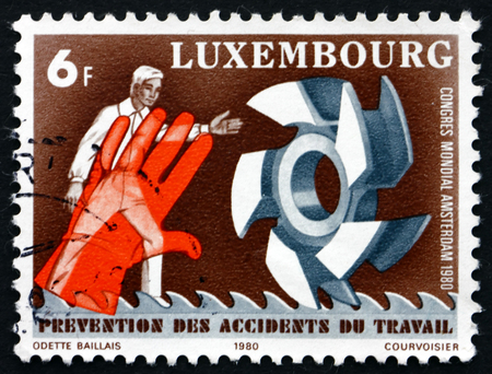 LUXEMBOURG - CIRCA 1980: a stamp printed in the Luxembourg shows Man, Hand and Tools, 9th World Congress on Prevention of Occupational Accidents, Amsterdam, circa 1980のeditorial素材