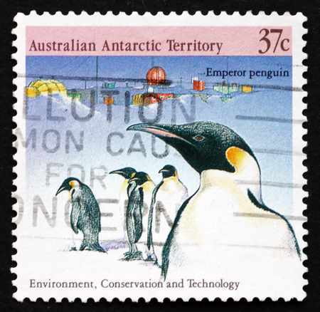 AUSTRALIA - CIRCA 1988: a stamp printed in the Australia, Australian Antarctic Territory shows Emperor Penguins and Davis Station, Environment Conservation and Technology, circa 1988のeditorial素材