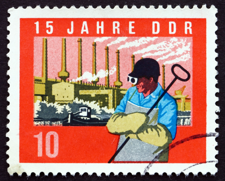 GDR - CIRCA 1964: a stamp printed in GDR shows Steel Worker, Factory, circa 1964のeditorial素材
