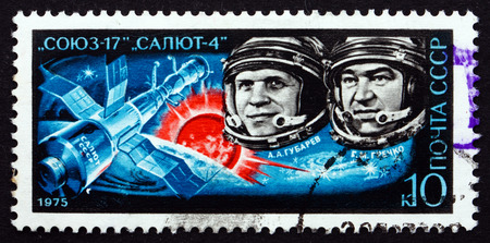 RUSSIA - CIRCA 1975: a stamp printed in the Russia shows A. A. Gubarev and G. M. Grechko aboard Soyuz 17 and Orbital Station Salyut 4, circa 1975のeditorial素材