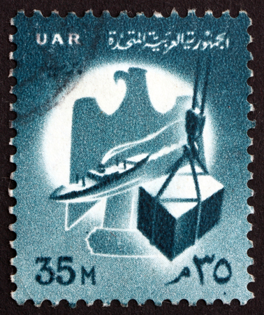 EGYPT - CIRCA 1958: a stamp printed in Egypt shows Commerce, Eagle, Ship and Cargo, circa 1958のeditorial素材