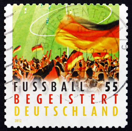 GERMANY - CIRCA 2012: a stamp printed in the Germany shows Crowd Waving Flag, German Football Enthusiasm, circa 2012のeditorial素材