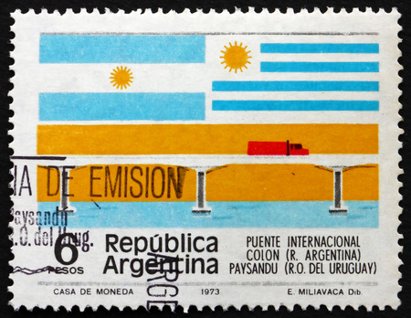 ARGENTINA - CIRCA 1975: a stamp printed in the Argentina shows International Bridge, Flags of Argentina and Uruguay, circa 1975のeditorial素材
