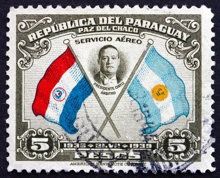 PARAGUAY - CIRCA 1939: a stamp printed in Paraguay shows President Roberto Maria Ortiz, Flags of Paraguay and Argentina, First Buenos Aires Peace Conference, circa 1939のeditorial素材