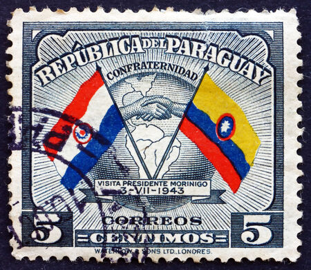 PARAGUAY - CIRCA 1945: a stamp printed in Paraguay shows Handshake, Map and Flags of Paraguay and Colombia, Goodwill Visit of President Higinio Morinigo, circa 1945のeditorial素材