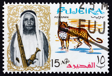 FUJEIRA - CIRCA 1964: a stamp printed in the Fujeira shows Leopard and Sheikh Mohammed Bin Hamad Al Sharqi, circa 1964のeditorial素材