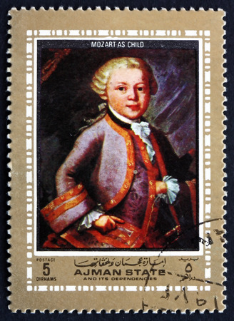 AJMAN - CIRCA 1972: a stamp printed in the Ajman shows Wolfgang Amadeus Mozart as Child, Austrian Composer, circa 1972のeditorial素材