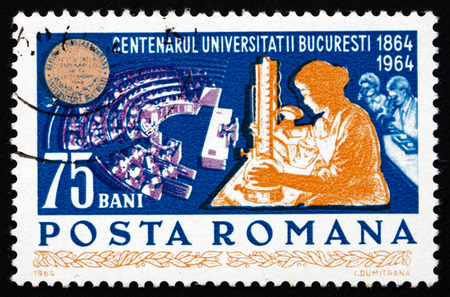 ROMANIA - CIRCA 1964: a stamp printed in the Romania shows Women Students in Laboratory and Auditorium, Centenary of the University of Bucharest, circa 1964のeditorial素材