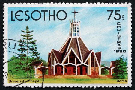 LESOTHO - CIRCA 1980: a stamp printed in the Lesotho shows University Chapel, Roma, Christmas, Tugboat Macuti, circa 1980のeditorial素材