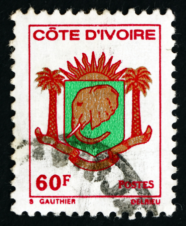 IVORY COAST - CIRCA 1976: a stamp printed in Ivory Coast shows Coat of Arms of Ivory Coast, circa 1976のeditorial素材