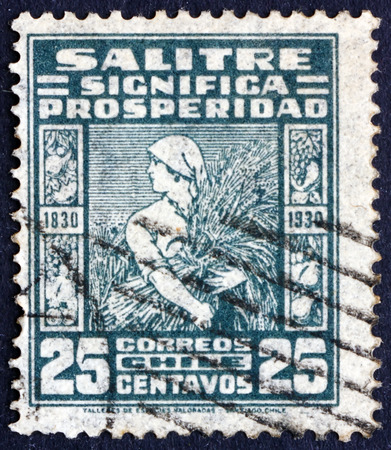 CHILE - CIRCA 1930: a stamp printed in the Chile shows Reaper with Ears of Corn, Prosperity of Saltpeter Trade, circa 1930のeditorial素材