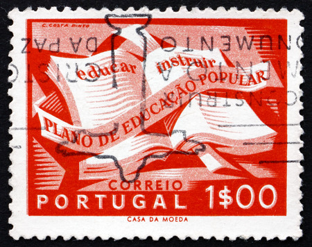 PORTUGAL - CIRCA 1954: a stamp printed in the Portugal shows Open Textbook, National Literacy Campaign, circa 1954のeditorial素材