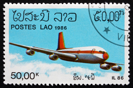 LAOS - CIRCA 1986: a stamp printed in Laos shows IL86 Soviet Jet Airliner, circa 1986のeditorial素材