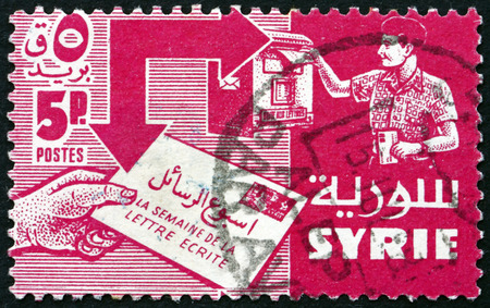 SYRIA - CIRCA 1957 a stamp printed in the Syria shows Mailing and Receiving Letter, International Letter Writing Week, circa 1957のeditorial素材