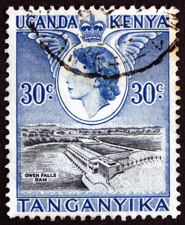 KENYA, UGANDA, TANZANIA - CIRCA 1954: a stamp printed in the Kenya, Uganda, Tanzania shows Owen Falls Dam, Visit of Queen Elizabeth II, circa 1954のeditorial素材