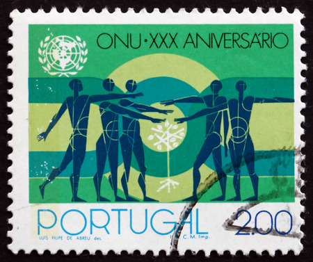 PORTUGAL - CIRCA 1975: a stamp printed in the Portugal shows People and Sapling, United Nations, 30th Anniversary, circa 1975のeditorial素材