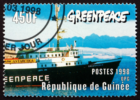 GUINEA - CIRCA 1998: a stamp printed in the Guinea shows Bow of Greenpeace Ship, circa 1998のeditorial素材