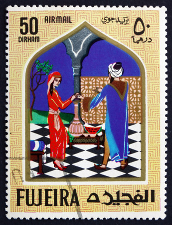 FUJEIRA - CIRCA 1967: a stamp printed in the Fujeira shows Scene from the Fairy Tale Aladdin and the Magic Lamp, circa 1967のeditorial素材