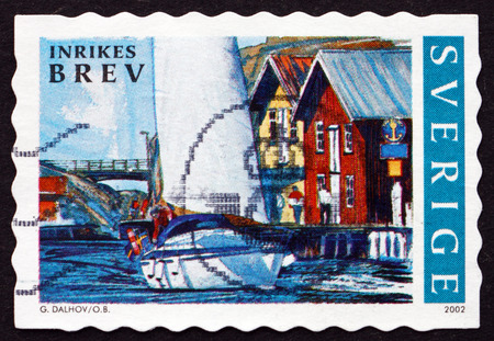SWEDEN - CIRCA 2002: a stamp printed in the Sweden shows Bridge, Sailboat, Waterfront Buildings, Summer in Bohuslan, Sweden, circa 2002のeditorial素材