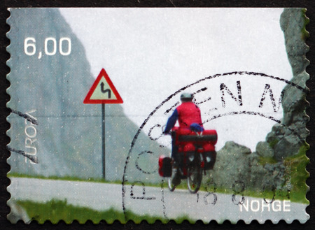 NORWAY - CIRCA 2004: a stamp printed in the Norway shows Bicyclist in Moskenes, Nordland County, Norway, circa 2004のeditorial素材