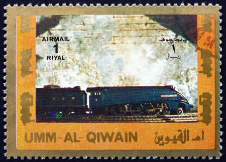 UMM AL-QUWAIN - CIRCA 1972: a stamp printed in the Umm al-Quwain shows Steam Locomotive, circa 1972のeditorial素材