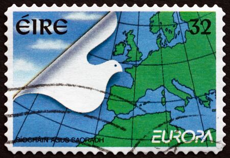 IRELAND - CIRCA 1995: A stamp printed in Ireland shows Stylized Dove and Map of Europe, Peace and Freedom, circa 1995のeditorial素材