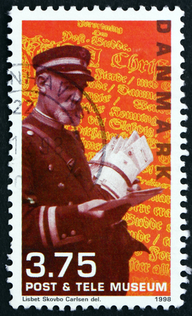 DENMARK - CIRCA 1998: a stamp printed in Denmark shows Postman, circa 1998のeditorial素材