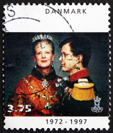 DENMARK - CIRCA 1997: a stamp printed in Denmark shows Queen Margrethe II with Crown Prince Frederik, 25th Anniversary of Coronation, circa 1997のeditorial素材