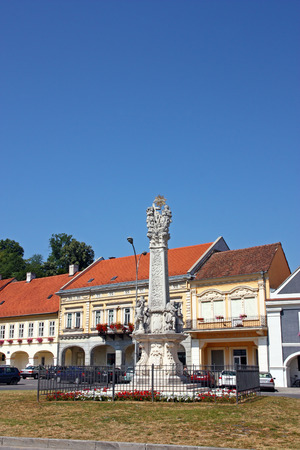 Monument to plague which has a statue of the Holy Trinity on top. Votive column located in the center of  Pozega main square, Croatiaのeditorial素材