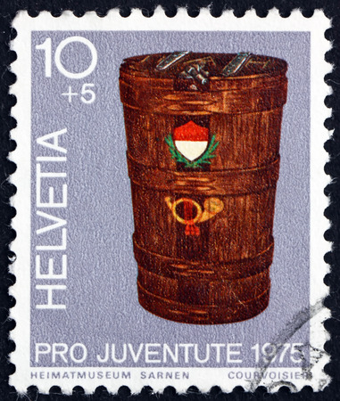 SWITZERLAND - CIRCA 1975: a stamp printed in the Switzerland shows Mail Bucket, circa 1975のeditorial素材