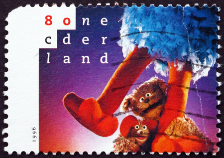 NETHERLANDS - CIRCA 1996: a stamp printed in Netherlands shows Pino, Ieiemienie and Tommie, Sesame Street in Netherlands, 20th Anniversary, circa 1996のeditorial素材