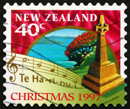 NEW ZEALAND - CIRCA 1997: a stamp printed in New Zealand shows Cross Marking Spot of First Christian Service, Rangihoua Bay, and Words from Christmas Carol, circa 1997のeditorial素材