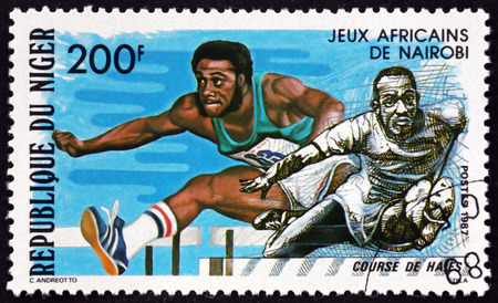 NIGER - CIRCA 1977: a stamp printed in Niger shows Hurdles, African Games, Nairobi, circa 1977のeditorial素材
