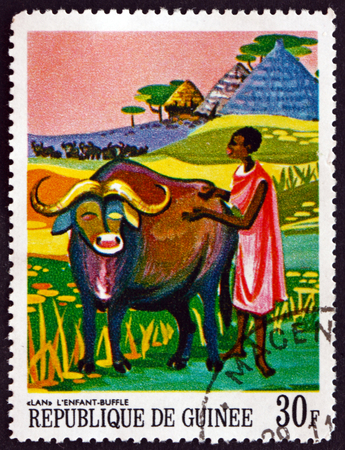 GUINEA - CIRCA 1967: a stamp printed in Guinea shows Lan, the Child Buffalo, African Legends, circa 1967のeditorial素材