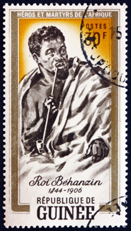 GUINEA - CIRCA 1962: a stamp printed in Guinea shows King Behanzin, King of Dahomey (Benin), was last independent ruler, circa 1962のeditorial素材