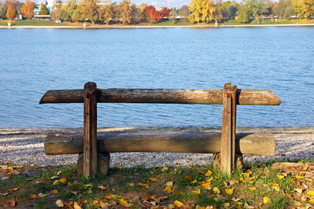Wooden bench with a view on the lakeの写真素材