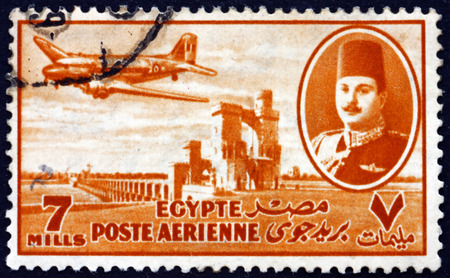 EGYPT - CIRCA 1947: a stamp printed in Egypt shows King Farouk, Delta Dam and DC-3 Plane, circa 1947のeditorial素材