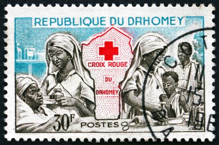 DAHOMEY - CIRCA 1962: a stamp printed in Dahomey shows Red cross nurses and map of Dahomey, circa 1962のeditorial素材