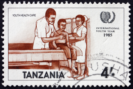 TANZANIA - CIRCA 1986: a stamp printed in Tanzania shows Doctor and Patient, Youth Health Care, circa 1986のeditorial素材