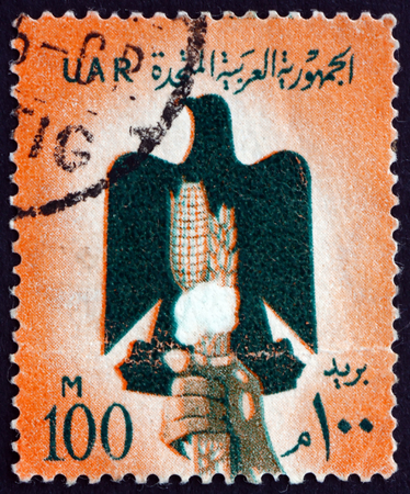 EGYPT - CIRCA 1960: a stamp printed in Egypt shows Eagle, Hand, Cotton and Grain, circa 1960のeditorial素材