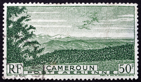 CAMEROON - CIRCA 1947: a stamp printed in Cameroon shows Birds over Mountains, circa 1947のeditorial素材