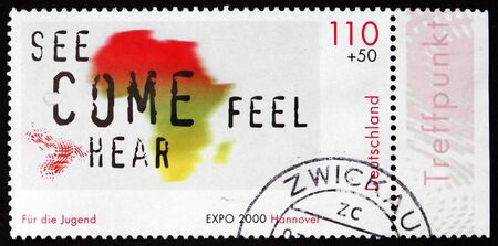 GERMANY - CIRCA 2000: a stamp printed in Germany shows Map of Africa and Words See, Come, Hear and Feel, circa 2000のeditorial素材