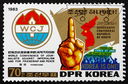 NORTH KOREA - CIRCA 1983: a stamp printed in North Korea shows Emblem, Map, Hand with Raised Forefinger, circa 1983のeditorial素材