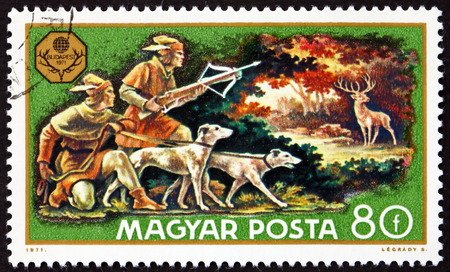 HUNGARY - CIRCA 1971: a stamp printed in Hungary shows Deer Hunt, World Hunting Exhibition, Budapest, circa 1971のeditorial素材