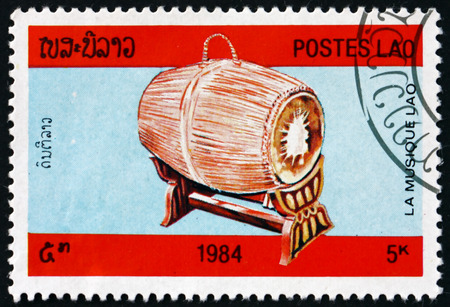 LAOS - CIRCA 1984: a stamp printed in Laos shows barrel drum, musical instrument, circa 1984のeditorial素材