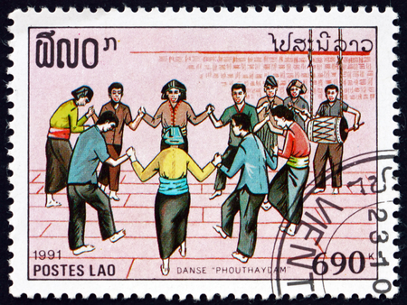 LAOS - CIRCA 1991: a stamp printed in Laos shows people dancing, musical celebration, circa 1991のeditorial素材