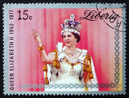 LIBERIA - CIRCA 1977: a stamp printed in Liberia shows Queen Elizabeth II Wearing Crown, 25th Anniversary of the Reign, circa 1977のeditorial素材