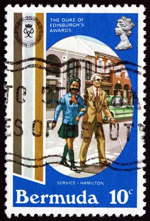 BERMUDA - CIRCA 1981: a stamp printed in Bermuda shows Girl Helping Blind Man Cross Street, Duke of Edinburgh's Awards, 25th Anniversary, circa 1981のeditorial素材